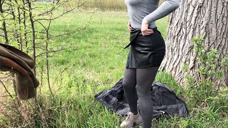 Girl in sexy leather shorts sucks outdoors and swallows cum