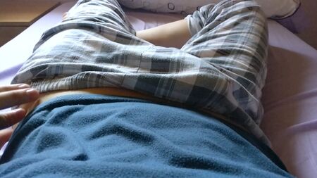Twink cute boy tempts to show his dick under his plaid trousers pajama