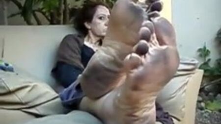Older woman showing her dirty feet
