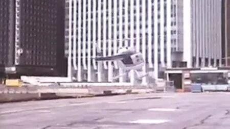 Old bearded man in a suit getting head in a helicopter