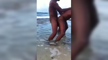Two black men having sex in the sea