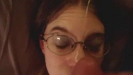 Nerdy brunette girl in glasses taking a big facial, POV